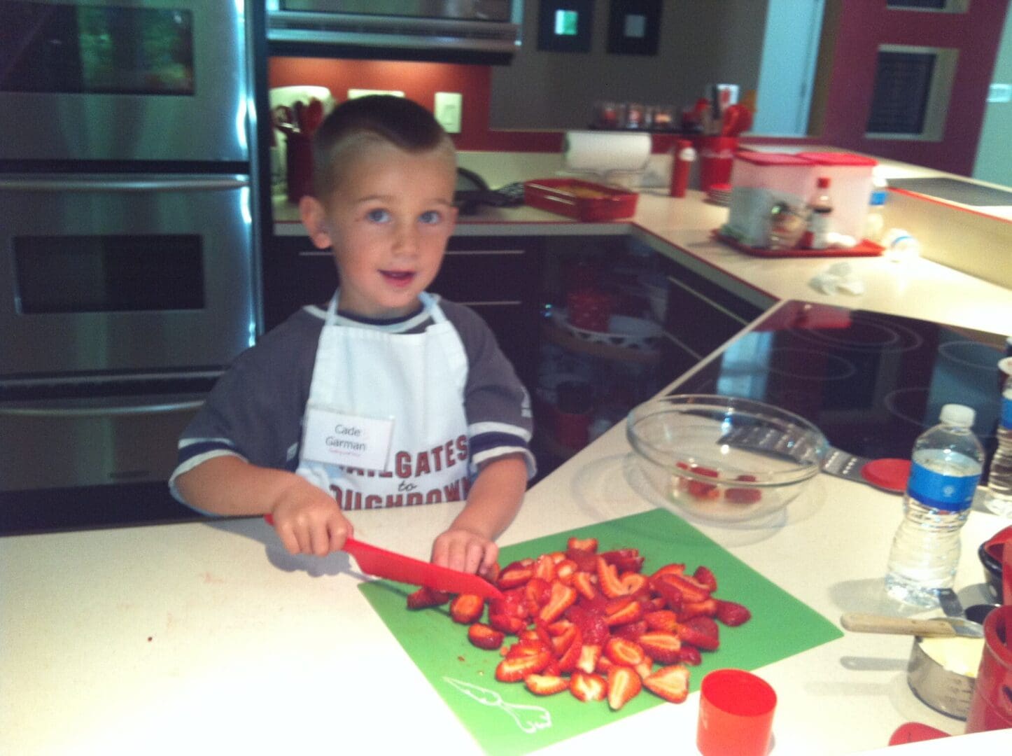 Toddler chopping strawberries