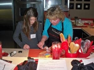 A woman and a girl cooking in a kitchen in eastern Iowa.