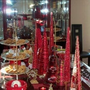 A christmas table with red and white decorations.