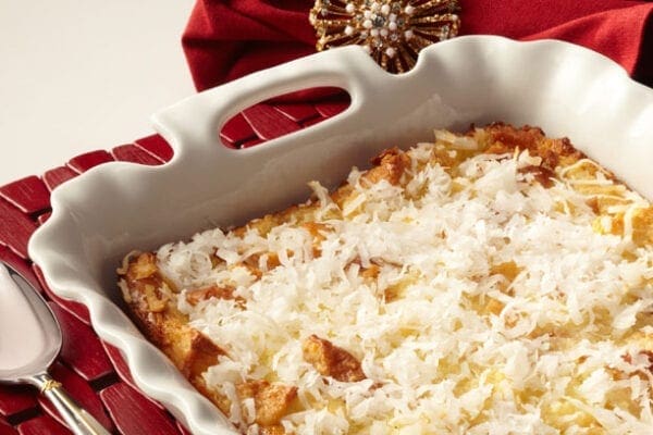 A casserole dish with shredded coconut on top.