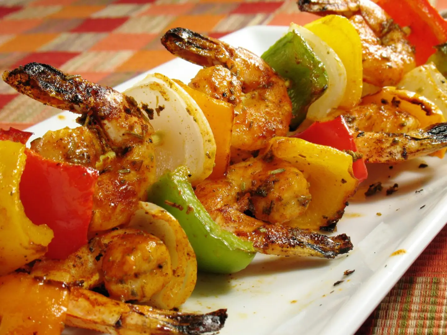 Shrimp skewers on a white plate.