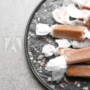 Caramel candy on a plate with salt.