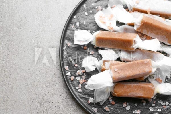 Caramel candy on a plate with salt.