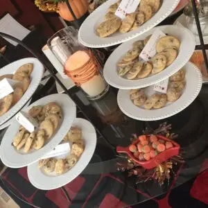 A table full of plates with cookies on them.