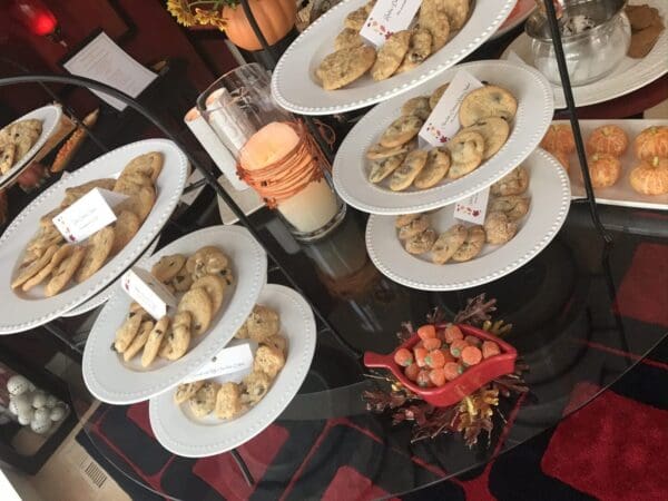 A table full of plates with cookies on them.