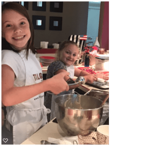 Toddler smiling and cooking in the kitchen